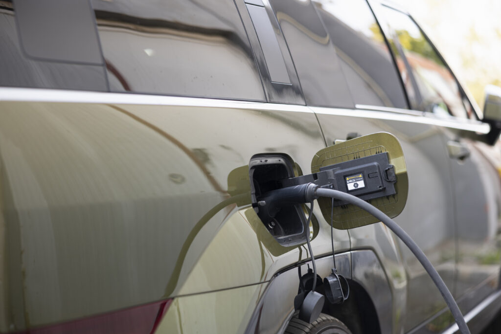Close up shot of EV plug connected to electric car